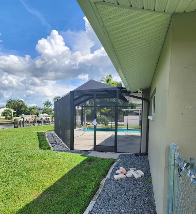 5325 Cocoa Ct, Cape Coral, FL 33904 - view of green lawn featuring an outdoor pool, glass enclosure, and a patio