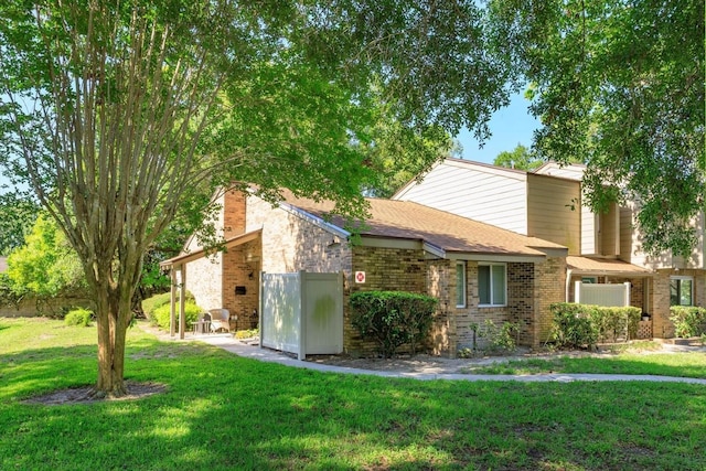 470 Oak Haven Dr Unit 470, Altamonte Springs, FL 32701 - mid-century modern home featuring a front lawn, a chimney, brick siding, and a shingled roof