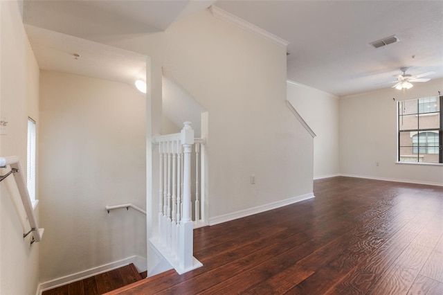 spare room featuring hardwood / wood-style flooring, crown molding, ceiling fan, and baseboards