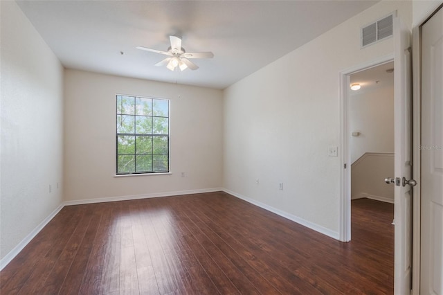 empty room with ceiling fan, dark wood-style floors, and baseboards