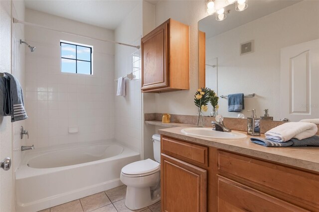 full bath with tile patterned flooring, toilet, vanity, and shower / washtub combination