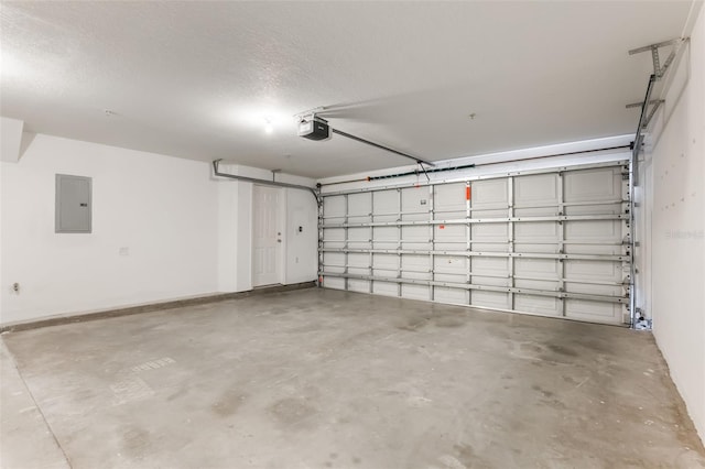 garage featuring electric panel and a garage door opener