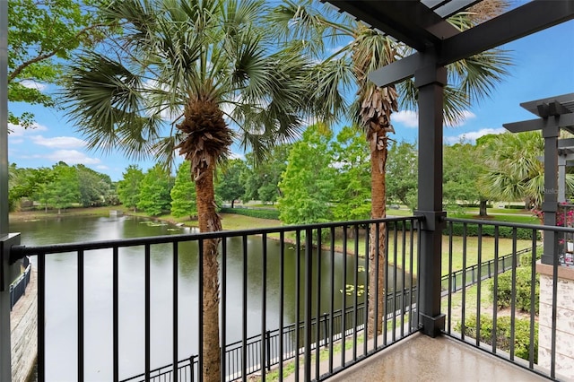 balcony featuring a water view and view of scattered trees