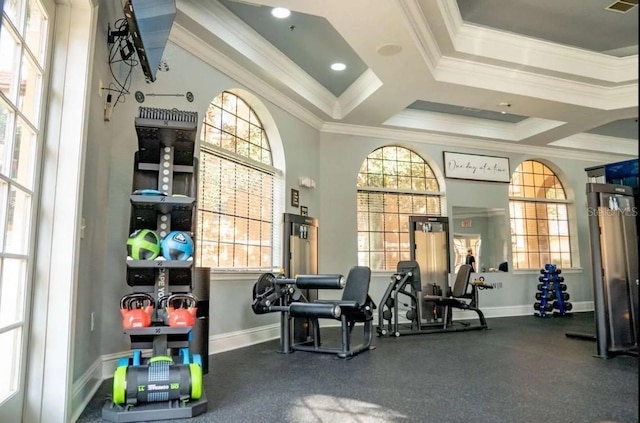 gym with crown molding and baseboards