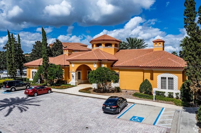 view of building exterior with uncovered parking