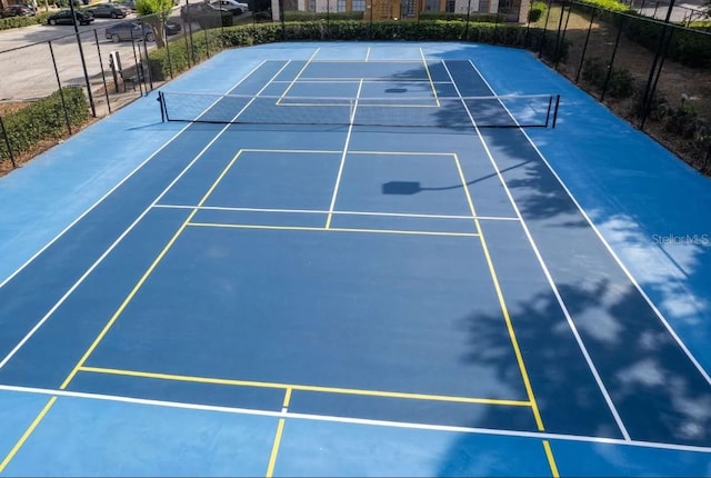 view of tennis court with fence