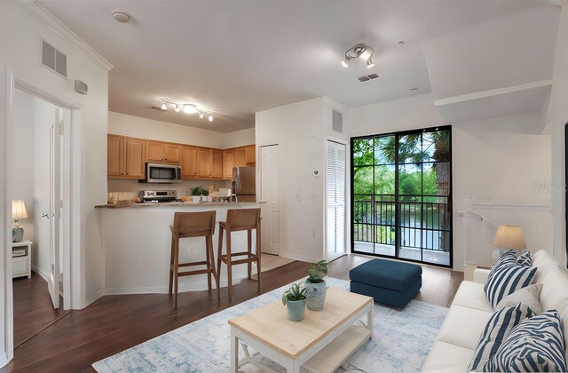 6107 Metrowest Blvd Unit 104, Orlando, FL 32835 - living room featuring wood finished floors and baseboards