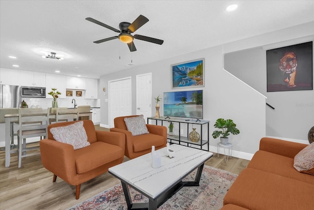 508 Boxelder Ave, Altamonte Springs, FL 32714 - living room with light wood-style flooring, baseboards, a ceiling fan, a textured ceiling, and recessed lighting