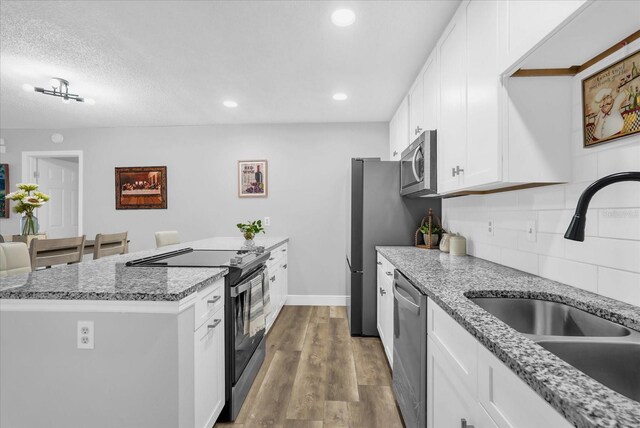 508 Boxelder Ave, Altamonte Springs, FL 32714 - kitchen with stainless steel appliances, a sink, decorative backsplash, white cabinetry, and light stone counters