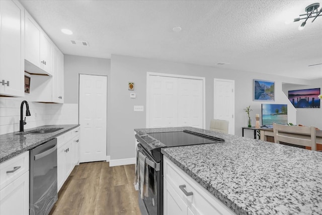 508 Boxelder Ave, Altamonte Springs, FL 32714 - kitchen with dishwasher, black range with electric cooktop, a sink, light stone counters, and a textured ceiling