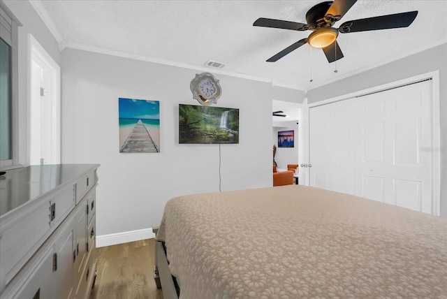 508 Boxelder Ave, Altamonte Springs, FL 32714 - bedroom with wood finished floors, crown molding, baseboards, a closet, and a ceiling fan