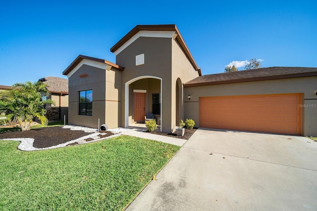 view of front of home with stucco siding, an attached garage, driveway, and a front yard