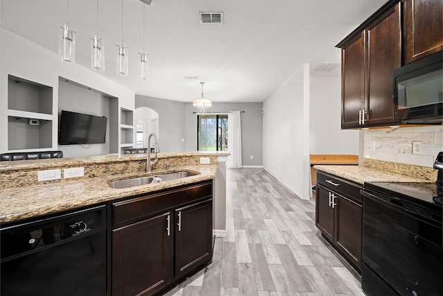 kitchen with black appliances, a sink, light stone countertops, baseboards, and tasteful backsplash