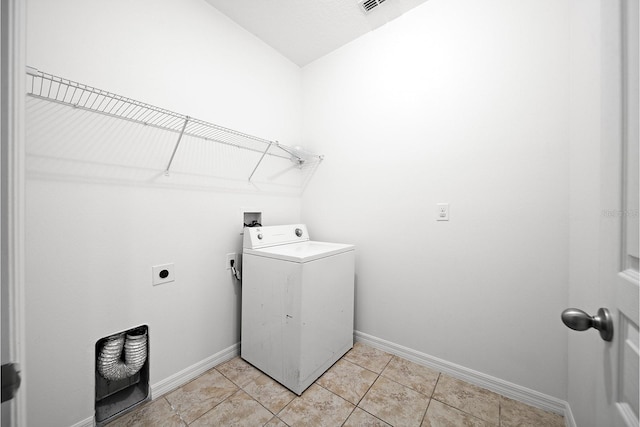 washroom featuring washer / clothes dryer, baseboards, and light tile patterned floors