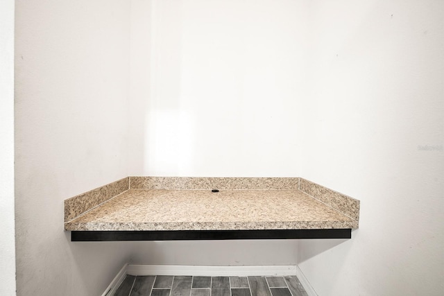 detailed view of baseboards and wood finished floors
