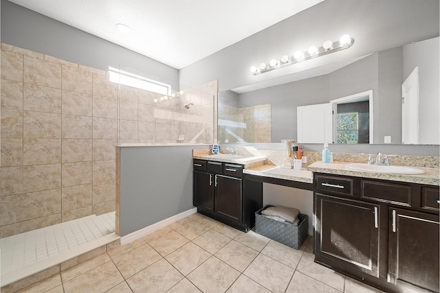 full bath featuring walk in shower, tile patterned floors, and double vanity