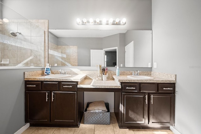 bathroom with walk in shower, double vanity, and tile patterned floors