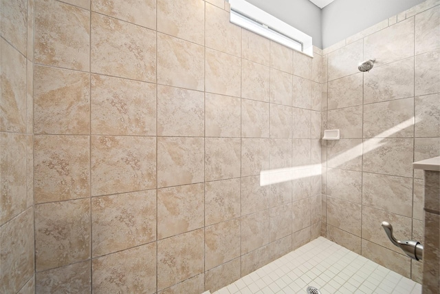 full bath with a tile shower