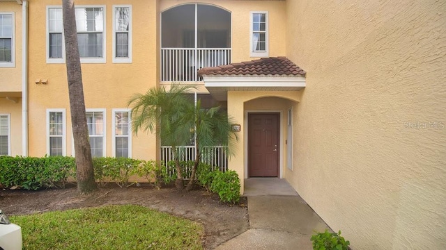 12220 Wild Iris Way Unit 103, Orlando, FL 32837 - entrance to property with stucco siding, a balcony, and a tile roof