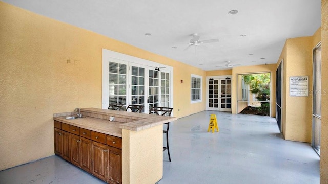 12220 Wild Iris Way Unit 103, Orlando, FL 32837 - view of patio featuring a sink, a ceiling fan, and exterior kitchen