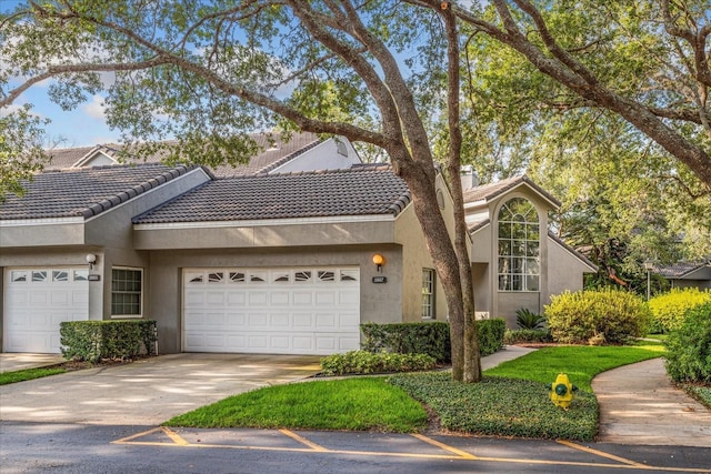 3987 Lancashire Ln Unit 3987, Longwood, FL 32779 - view of front of home featuring stucco siding, an attached garage, and a tile roof