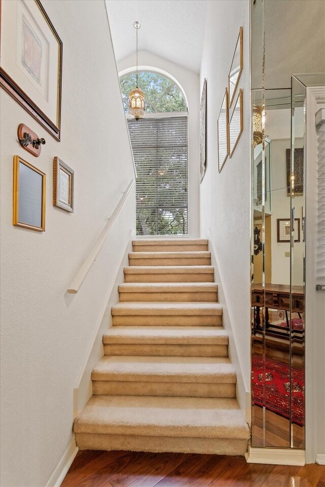 3987 Lancashire Ln Unit 3987, Longwood, FL 32779 - stairway with wood finished floors, lofted ceiling, and baseboards
