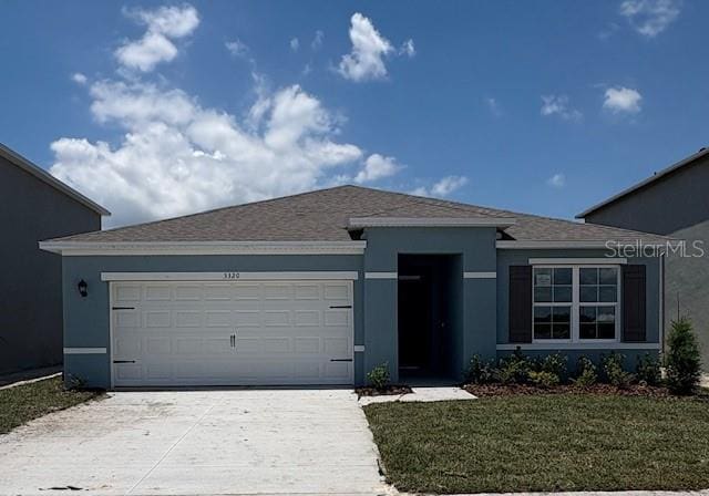 ranch-style home featuring concrete driveway, an attached garage, and stucco siding
