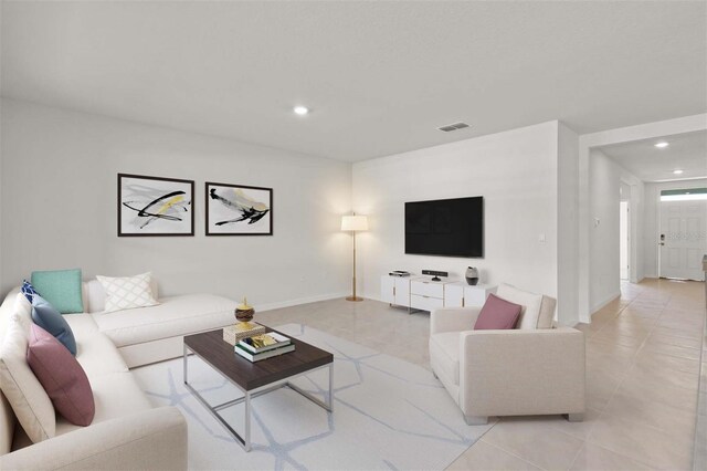 living room featuring light tile patterned flooring, recessed lighting, and baseboards