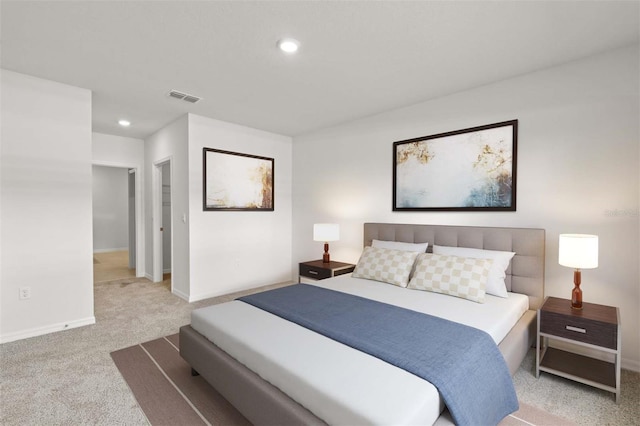 carpeted bedroom featuring baseboards and recessed lighting