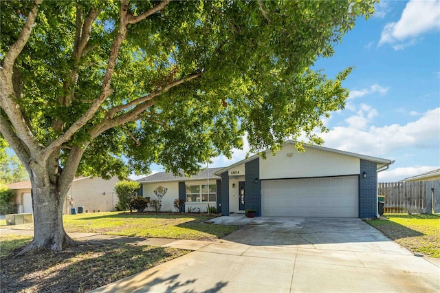 1804 W Shores Rd, Melbourne, FL 32935 - view of front of house featuring a garage, concrete driveway, and brick siding