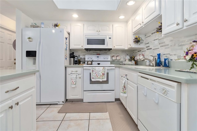 1804 W Shores Rd, Melbourne, FL 32935 - kitchen featuring white appliances, white cabinetry, light countertops, light tile patterned flooring, and recessed lighting