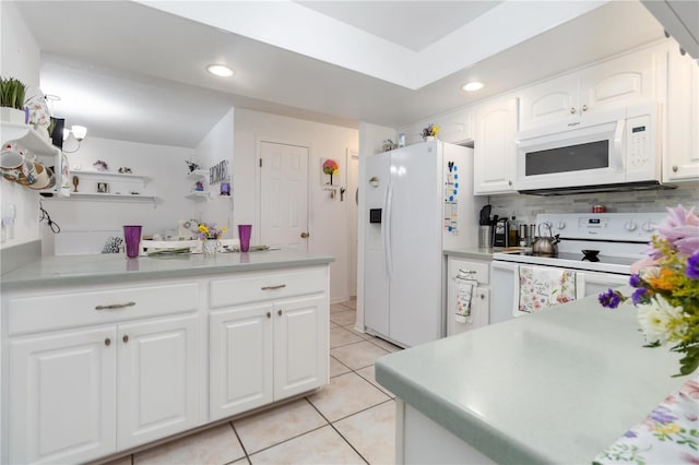 1804 W Shores Rd, Melbourne, FL 32935 - kitchen featuring white appliances, light tile patterned flooring, white cabinetry, recessed lighting, and light countertops