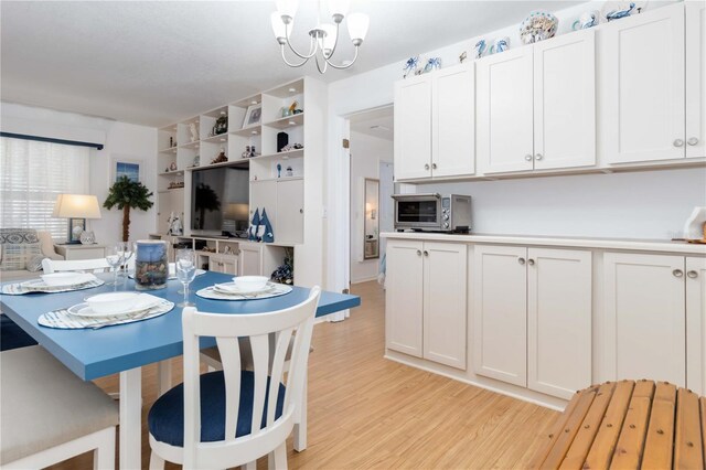 1804 W Shores Rd, Melbourne, FL 32935 - dining space featuring light wood-type flooring and a chandelier