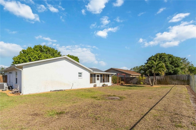 1804 W Shores Rd, Melbourne, FL 32935 - back of property featuring cooling unit, stucco siding, and a sunroom