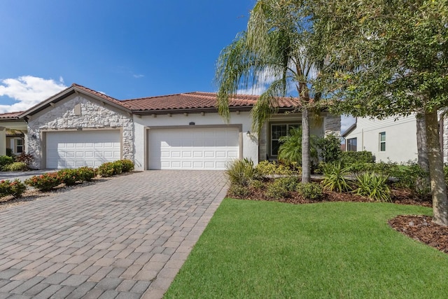 2532 Avolet Ct, Lakewood Ranch, FL 34211 - mediterranean / spanish home with a tile roof, stucco siding, a garage, driveway, and a front yard
