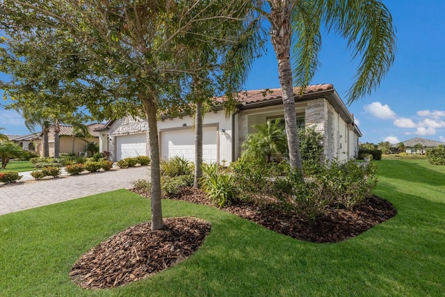2532 Avolet Ct, Lakewood Ranch, FL 34211 - view of home's exterior featuring stucco siding, a lawn, driveway, a tiled roof, and a garage