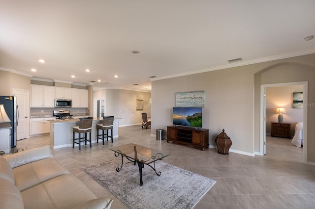 2532 Avolet Ct, Lakewood Ranch, FL 34211 - living area with ornamental molding, recessed lighting, baseboards, arched walkways, and light tile patterned flooring