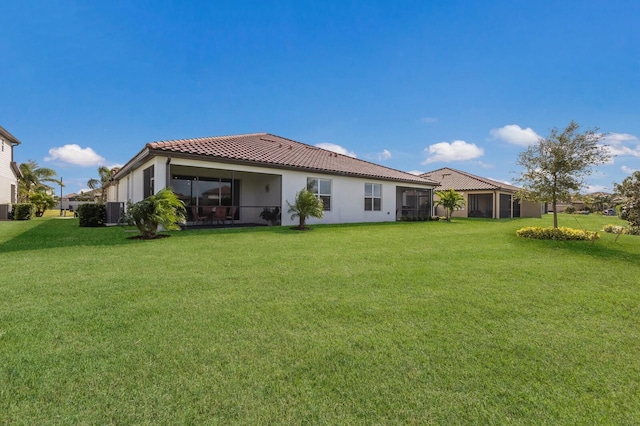 2532 Avolet Ct, Lakewood Ranch, FL 34211 - rear view of property with a tiled roof, a yard, central AC, and a sunroom