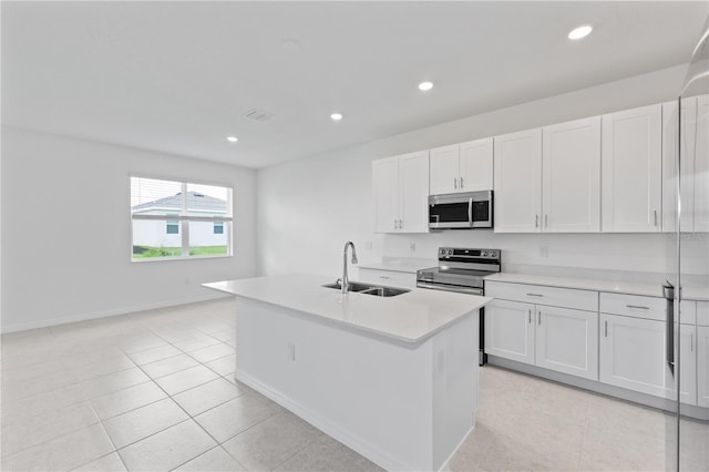 499 Silver Palm Dr, Haines City, FL 33844 - kitchen featuring stainless steel appliances, light countertops, white cabinetry, recessed lighting, and a kitchen island with sink