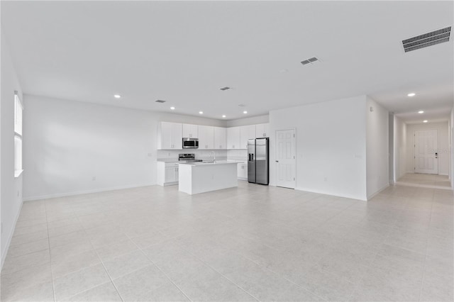 499 Silver Palm Dr, Haines City, FL 33844 - unfurnished living room with recessed lighting and light tile patterned flooring