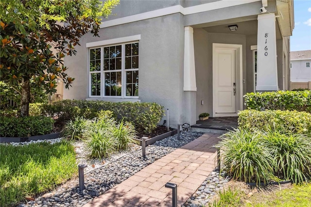 8160 Iron Mountain Trl, Windermere, FL 34786 - property entrance featuring stucco siding and a security system