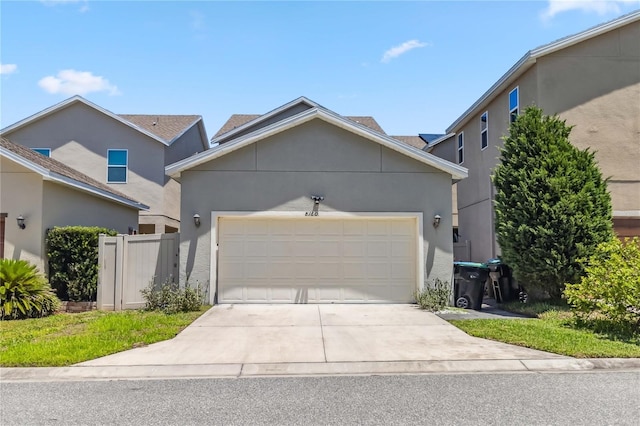 8160 Iron Mountain Trl, Windermere, FL 34786 - traditional-style house featuring an attached garage, stucco siding, concrete driveway, and fence