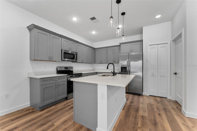 7104 N Maltese Dr, Citrus Springs, FL 34433 - kitchen featuring appliances with stainless steel finishes, a sink, gray cabinetry, light countertops, and recessed lighting