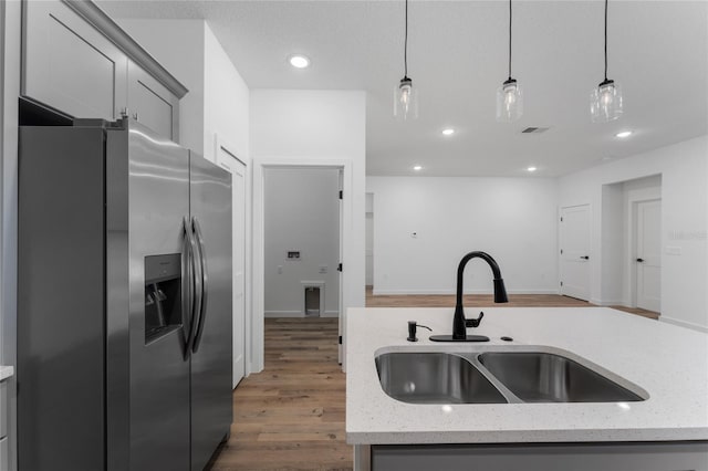 7104 N Maltese Dr, Citrus Springs, FL 34433 - kitchen with stainless steel fridge with ice dispenser, a sink, gray cabinets, pendant lighting, and wood finished floors