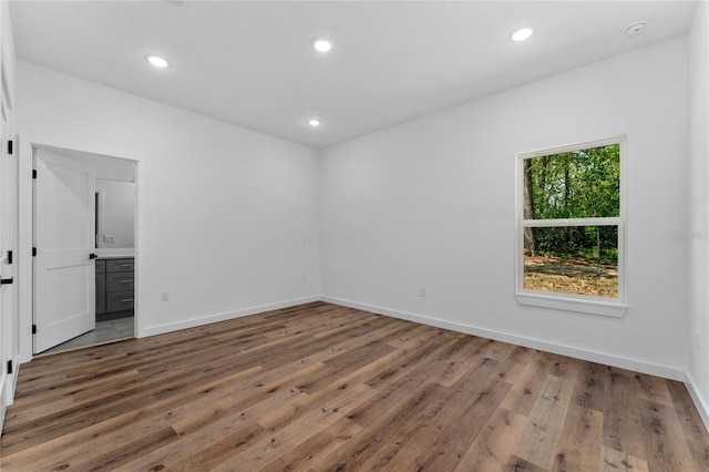 7104 N Maltese Dr, Citrus Springs, FL 34433 - unfurnished room with wood finished floors, baseboards, recessed lighting, and a smoke detector