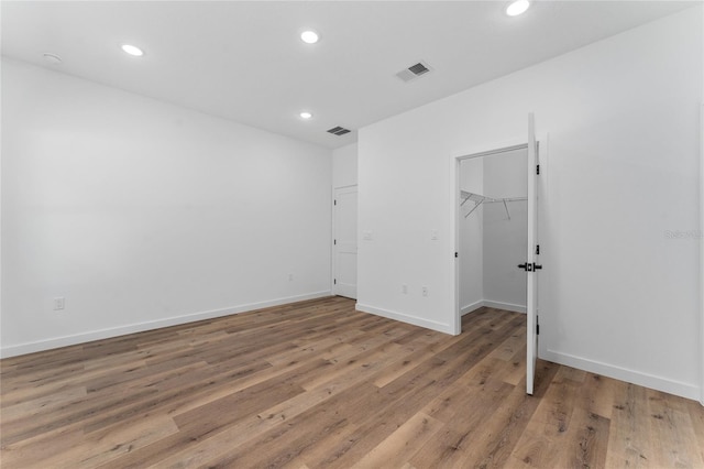 7104 N Maltese Dr, Citrus Springs, FL 34433 - unfurnished bedroom featuring recessed lighting, light wood-style flooring, baseboards, a spacious closet, and a closet