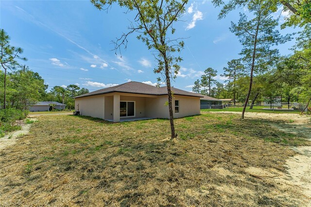 7104 N Maltese Dr, Citrus Springs, FL 34433 - rear view of property featuring stucco siding