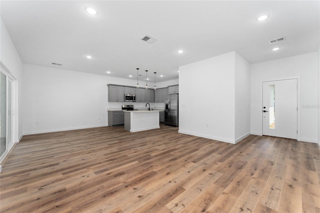 7104 N Maltese Dr, Citrus Springs, FL 34433 - unfurnished living room featuring light wood-type flooring and recessed lighting