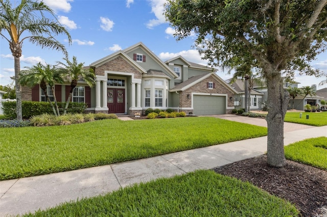 724 Duff Dr, Winter Garden, FL 34787 - craftsman inspired home with stone siding, a garage, driveway, a front lawn, and stucco siding
