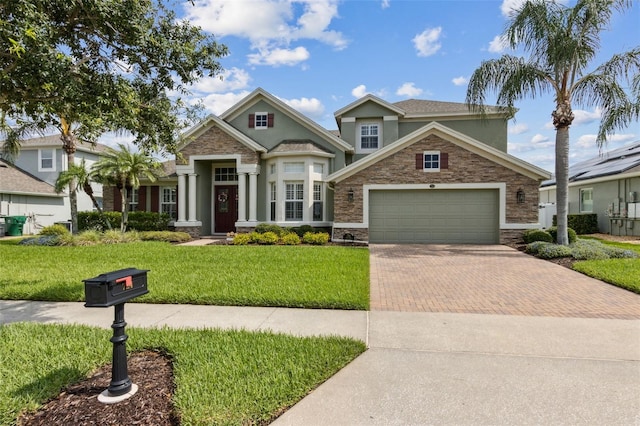 724 Duff Dr, Winter Garden, FL 34787 - craftsman-style house featuring decorative driveway, stucco siding, a garage, a front lawn, and stone siding